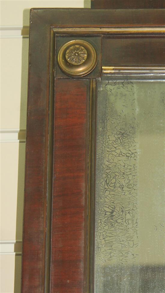 A French Empire style mahogany and brass mounted wall mirror, 3ft 11in. x 1ft 11.75in.